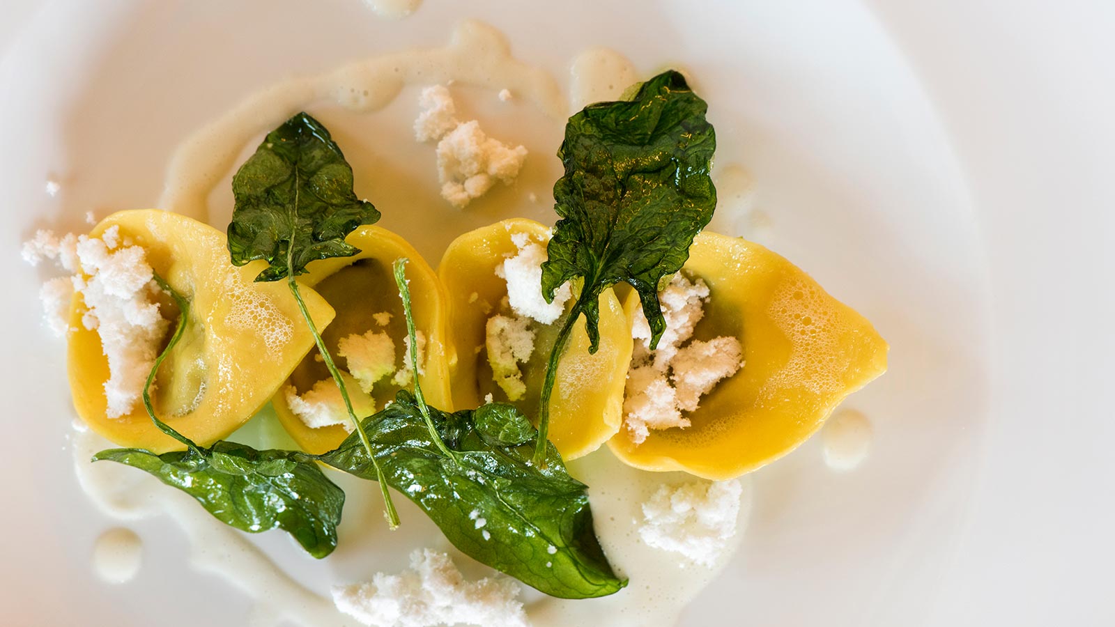 a plate of food with cheese and spinach