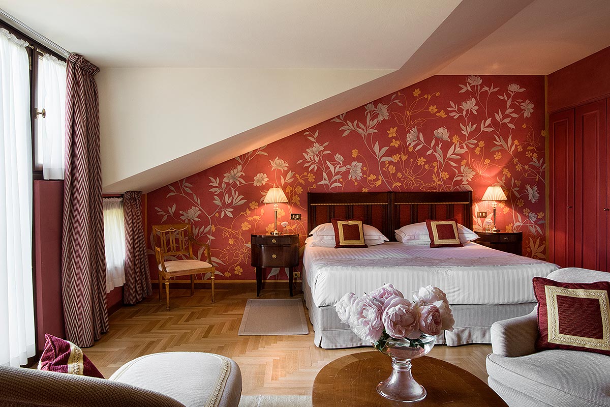 a bedroom with a bed and chairs