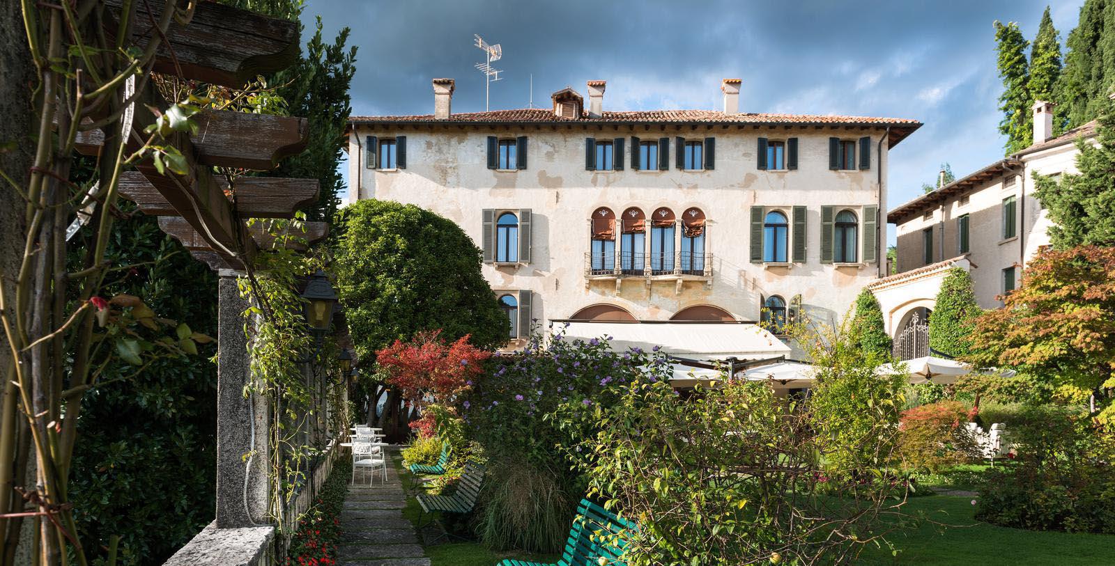 a building with a garden and chairs