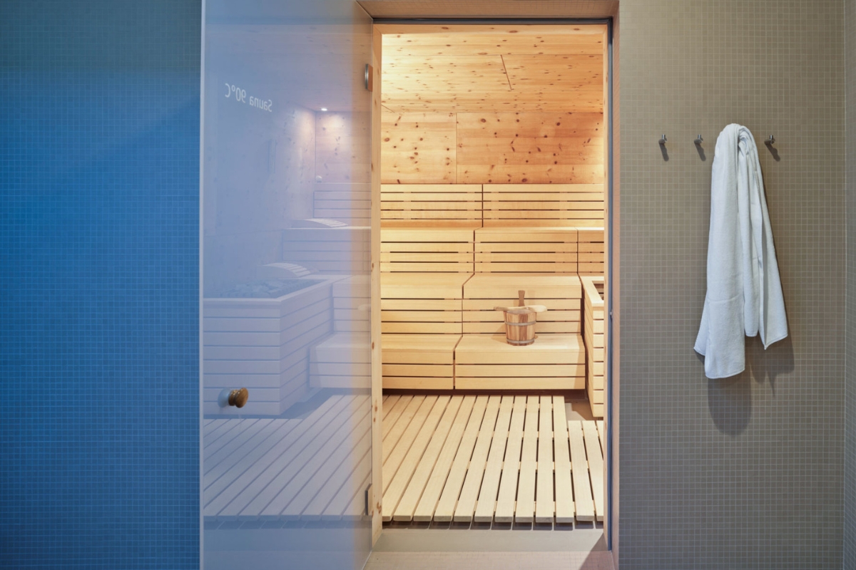 a wooden sauna with a glass door