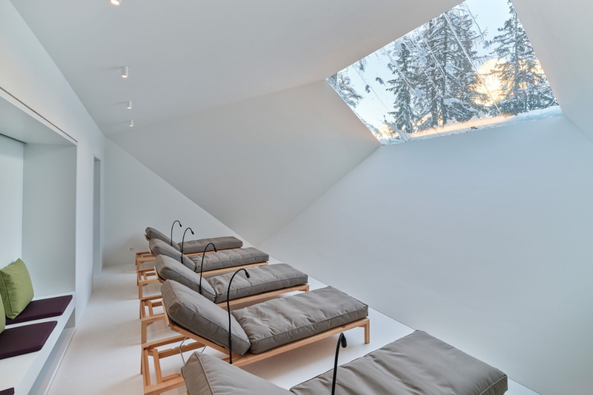 a room with a skylight and chairs