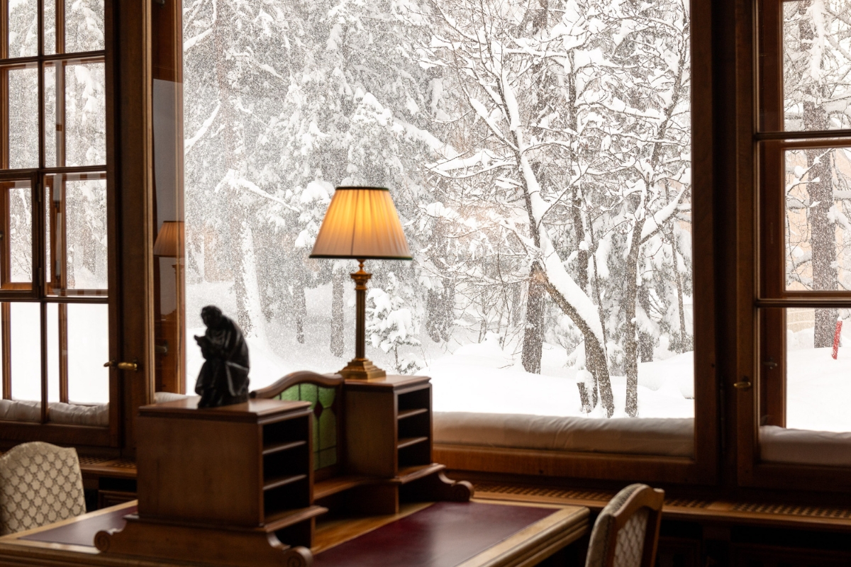 a lamp on a desk next to a window