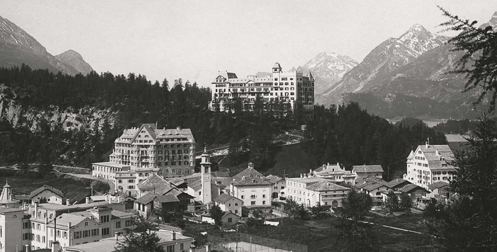 a group of buildings on a hill with Banff Springs Hotel in the background