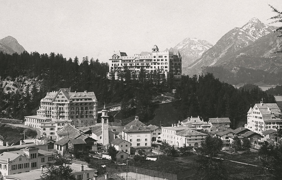 a group of buildings on a hill with Banff Springs Hotel in the background