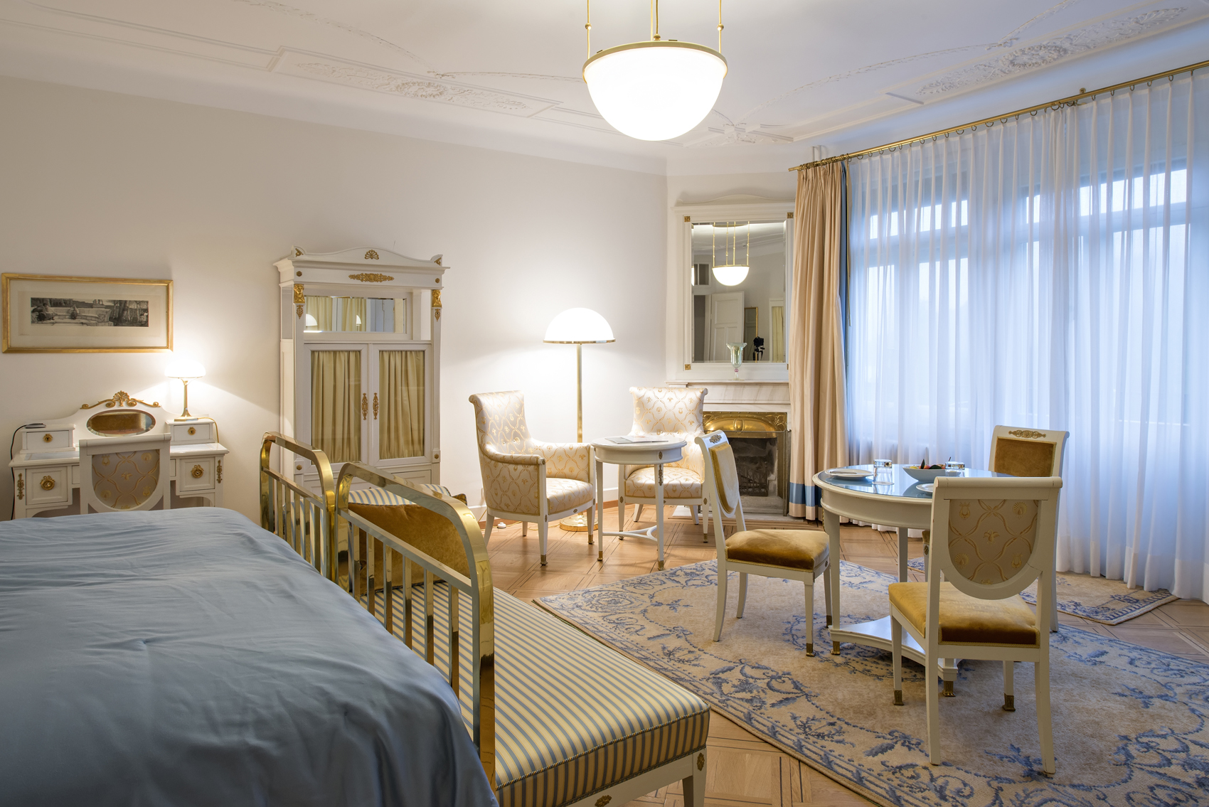 a bedroom with a bed and a table and chairs