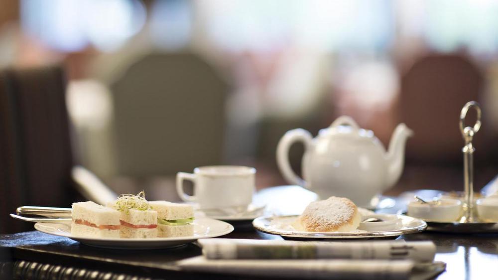 a table with plates of food and teapot