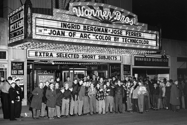 a group of people standing in front of a marquee