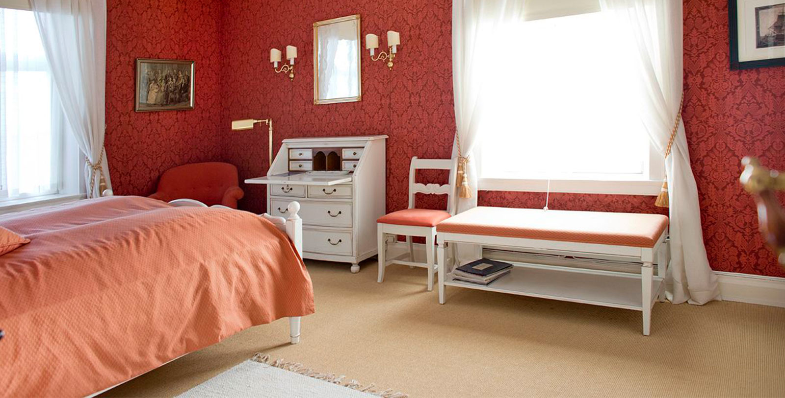 a bedroom with a desk and a bed