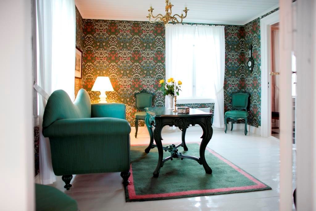 a living room with a table and chairs