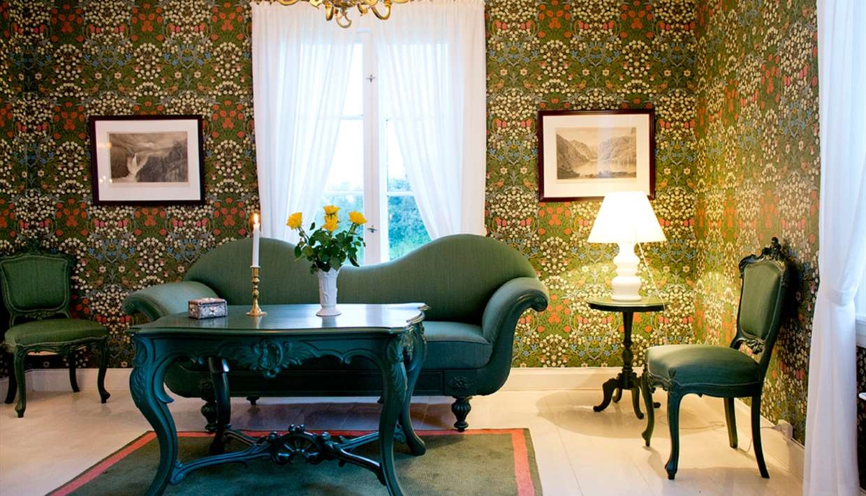 a living room with a green couch and a table