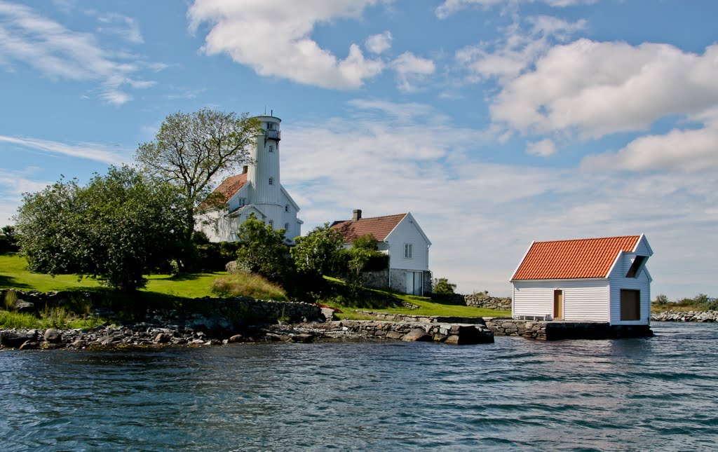 a white house next to a body of water
