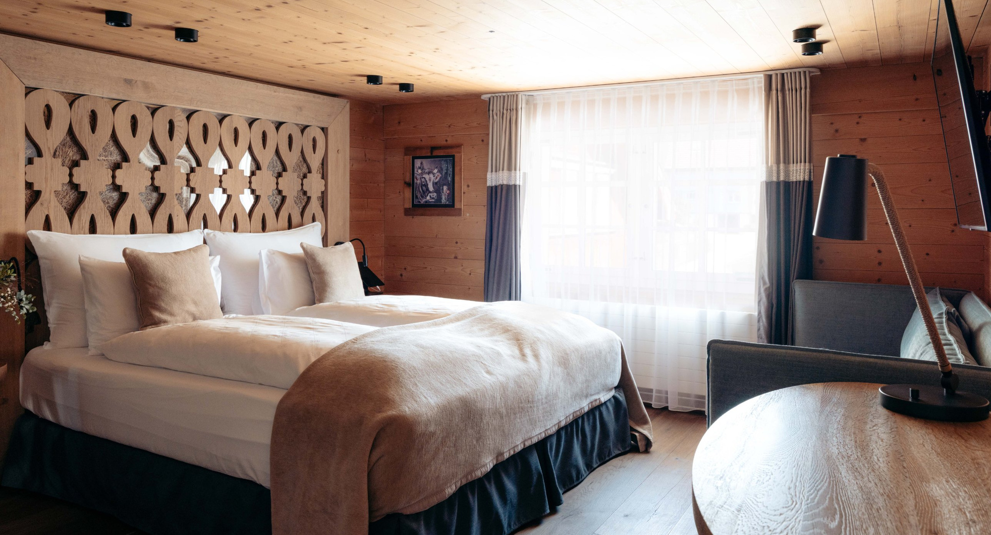 a room with two beds and a table
