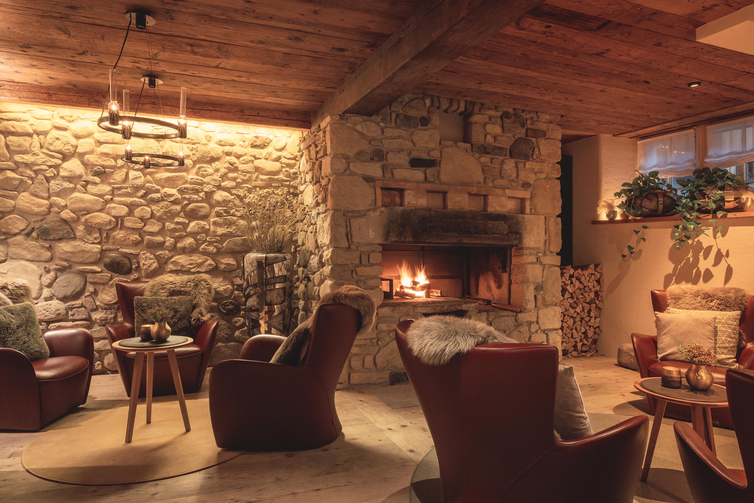 a room with a stone fireplace and chairs