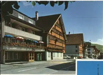 a building with balconies and a parking lot