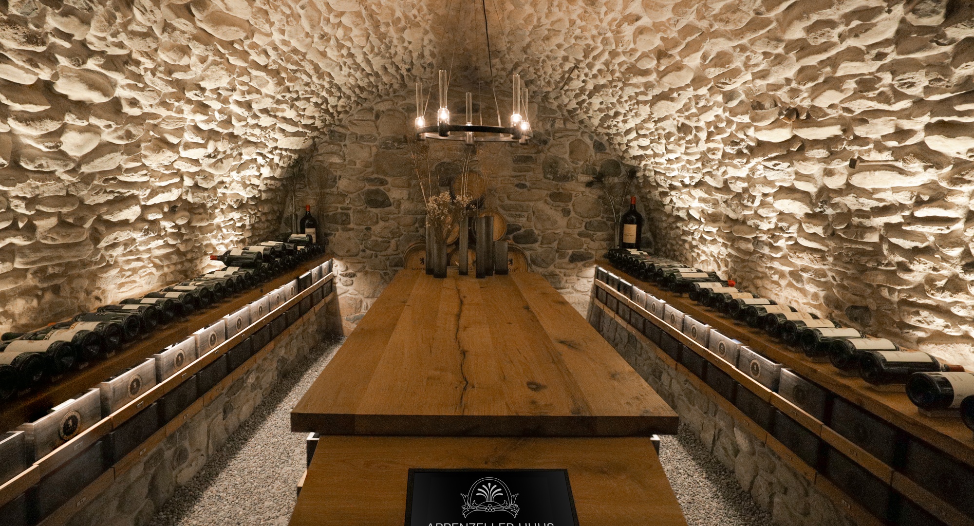 a wine cellar with a table and bottles of wine