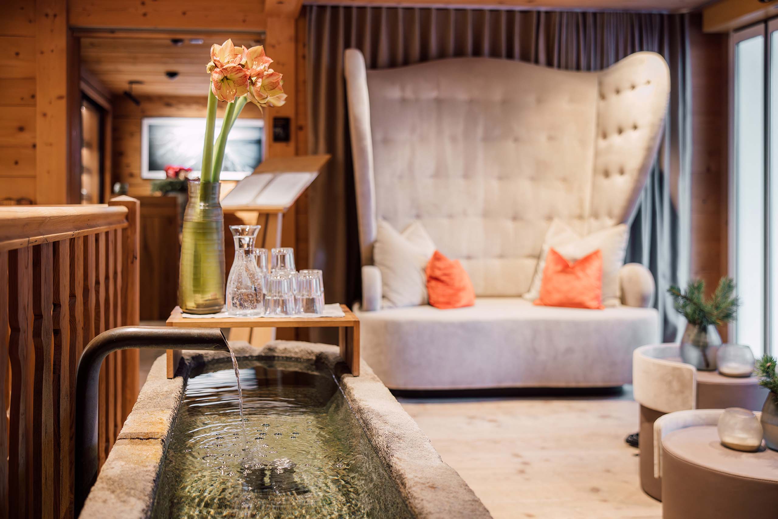 a water fountain in a room with a large couch and a large bed