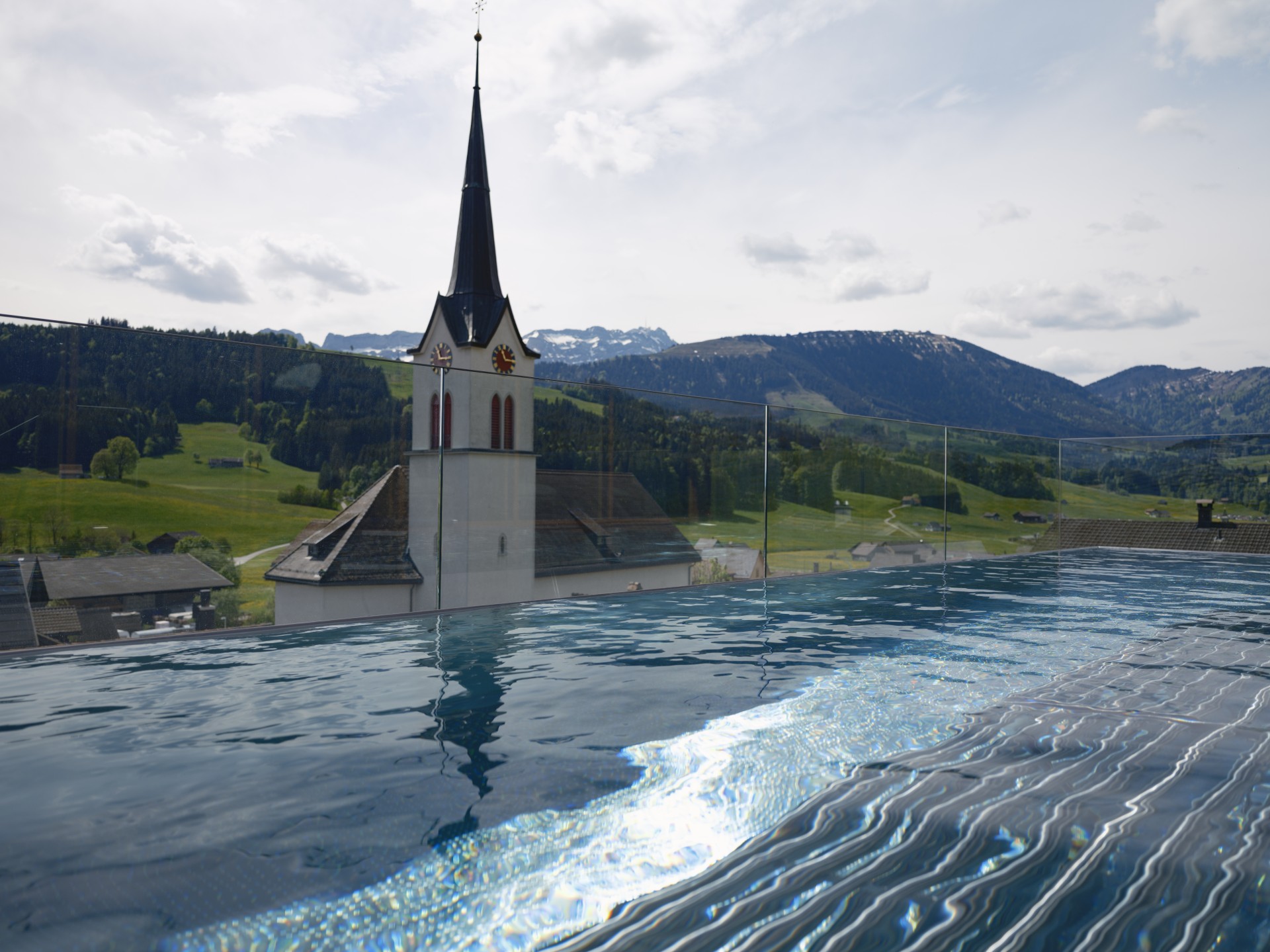 a pool with a building and a steeple