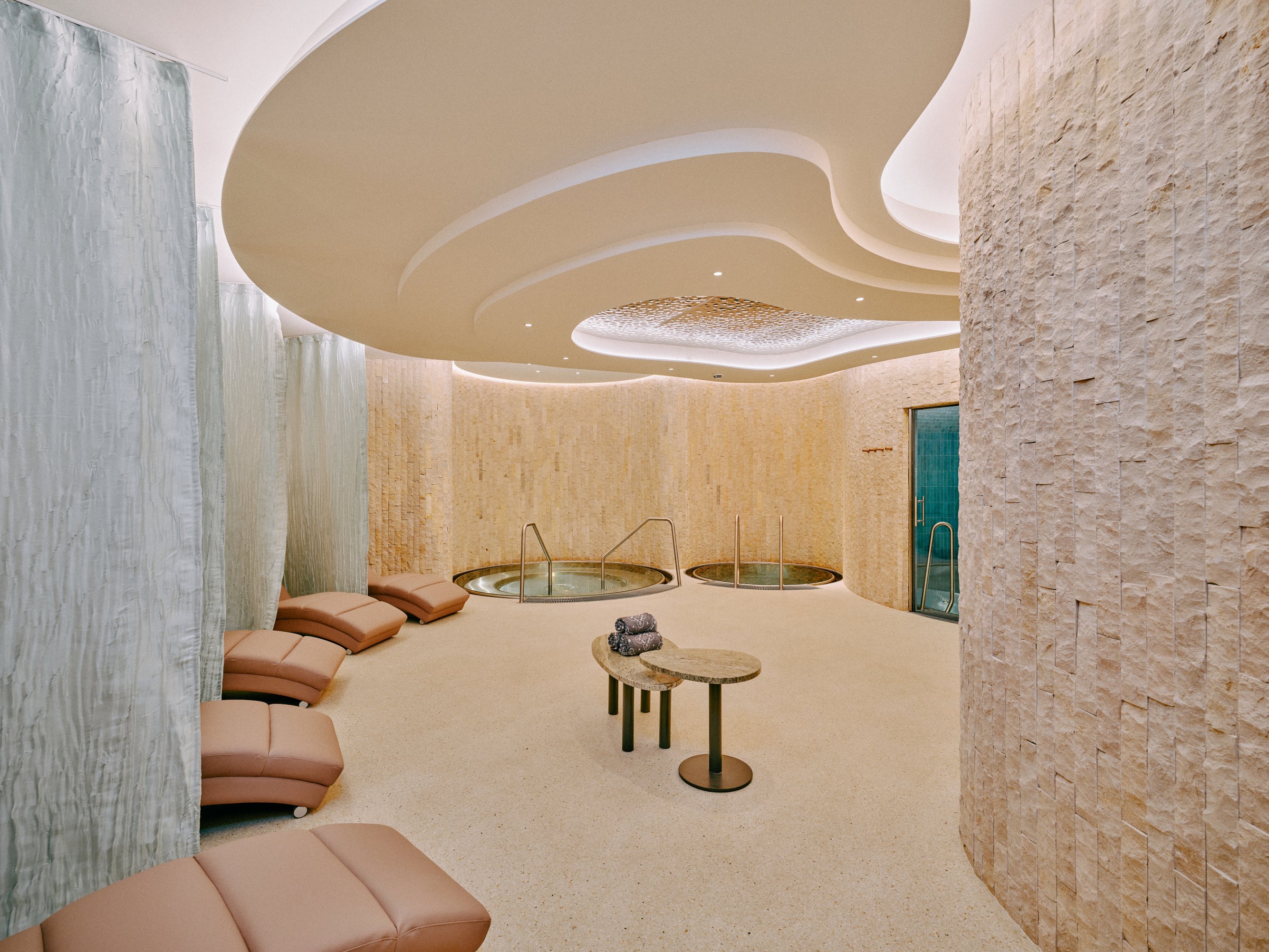 a room with a round table and chairs