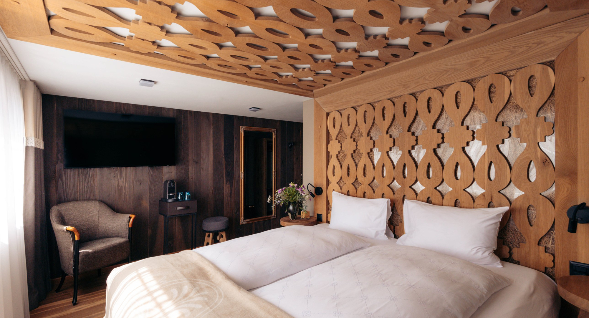 a bed with a carved headboard
