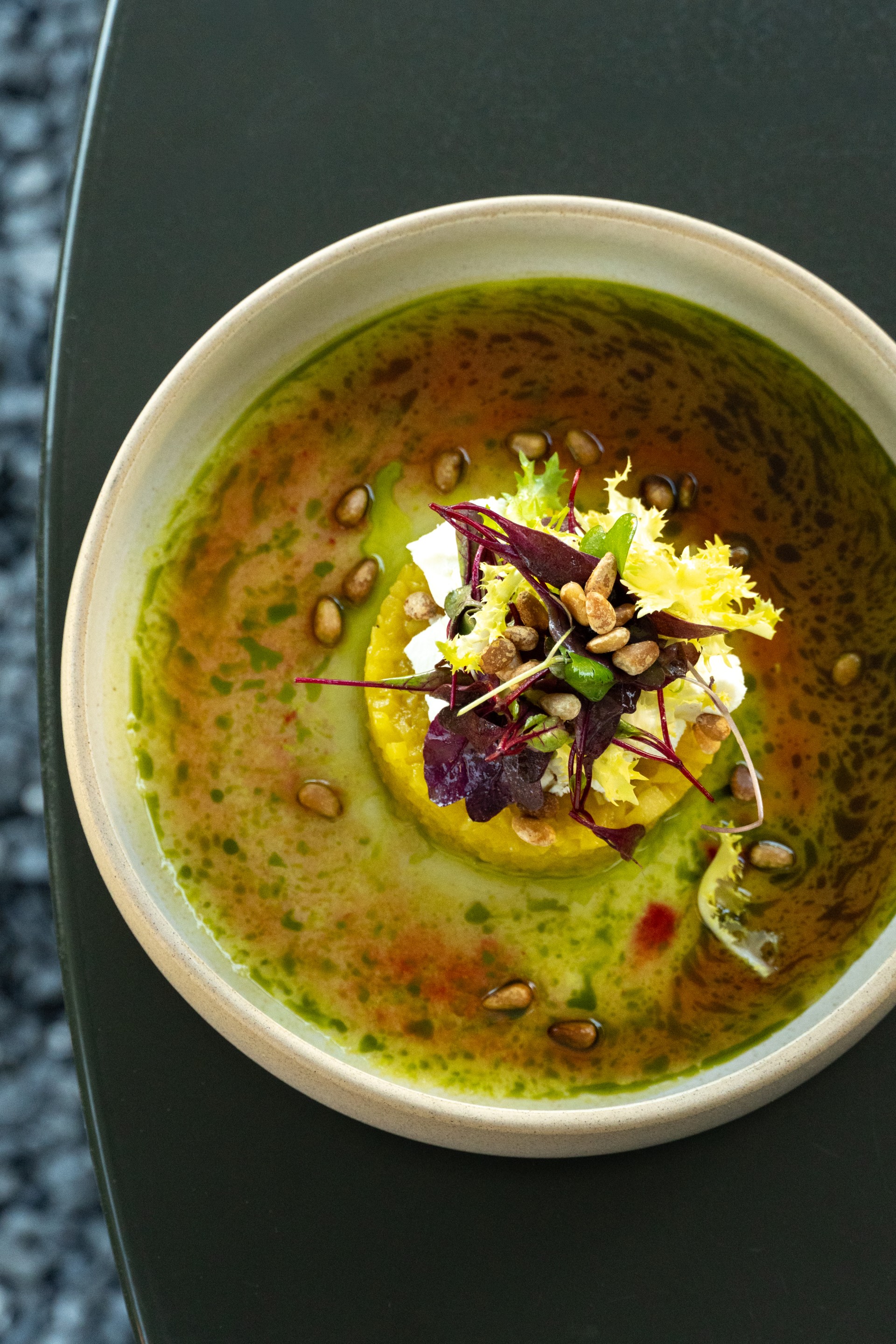 a bowl of soup with vegetables and seeds