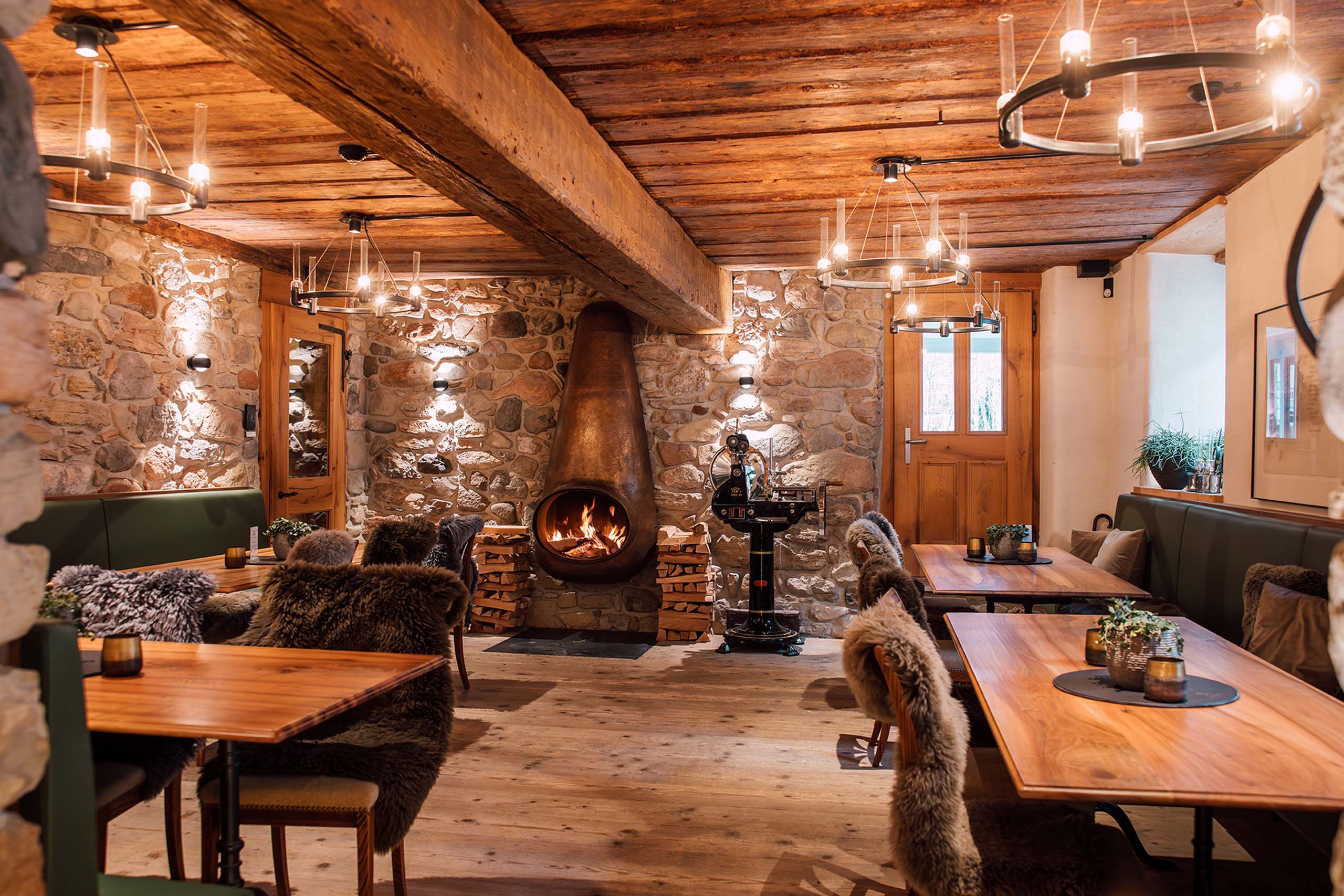 a room with a fireplace and tables