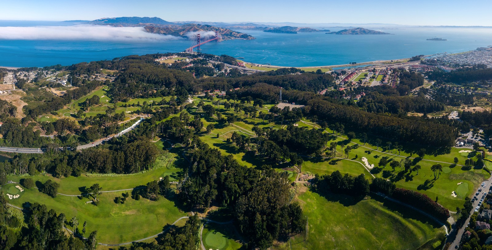 a aerial view of a park and a bridge