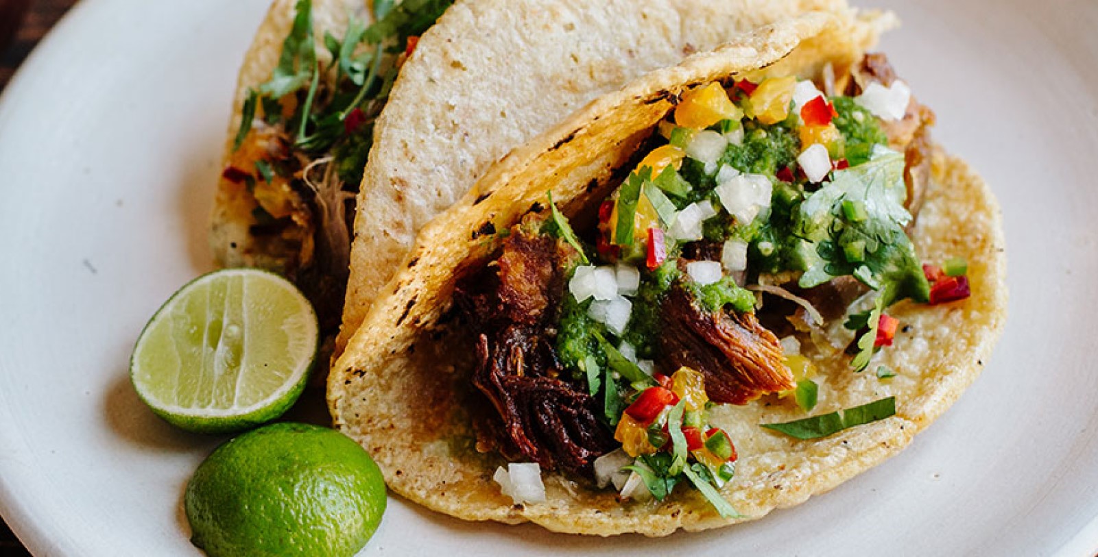 a tacos with meat and salsa on a plate