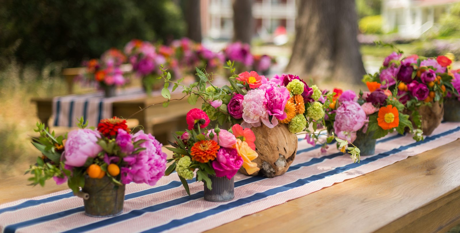 a group of flowers in a vases on a table
