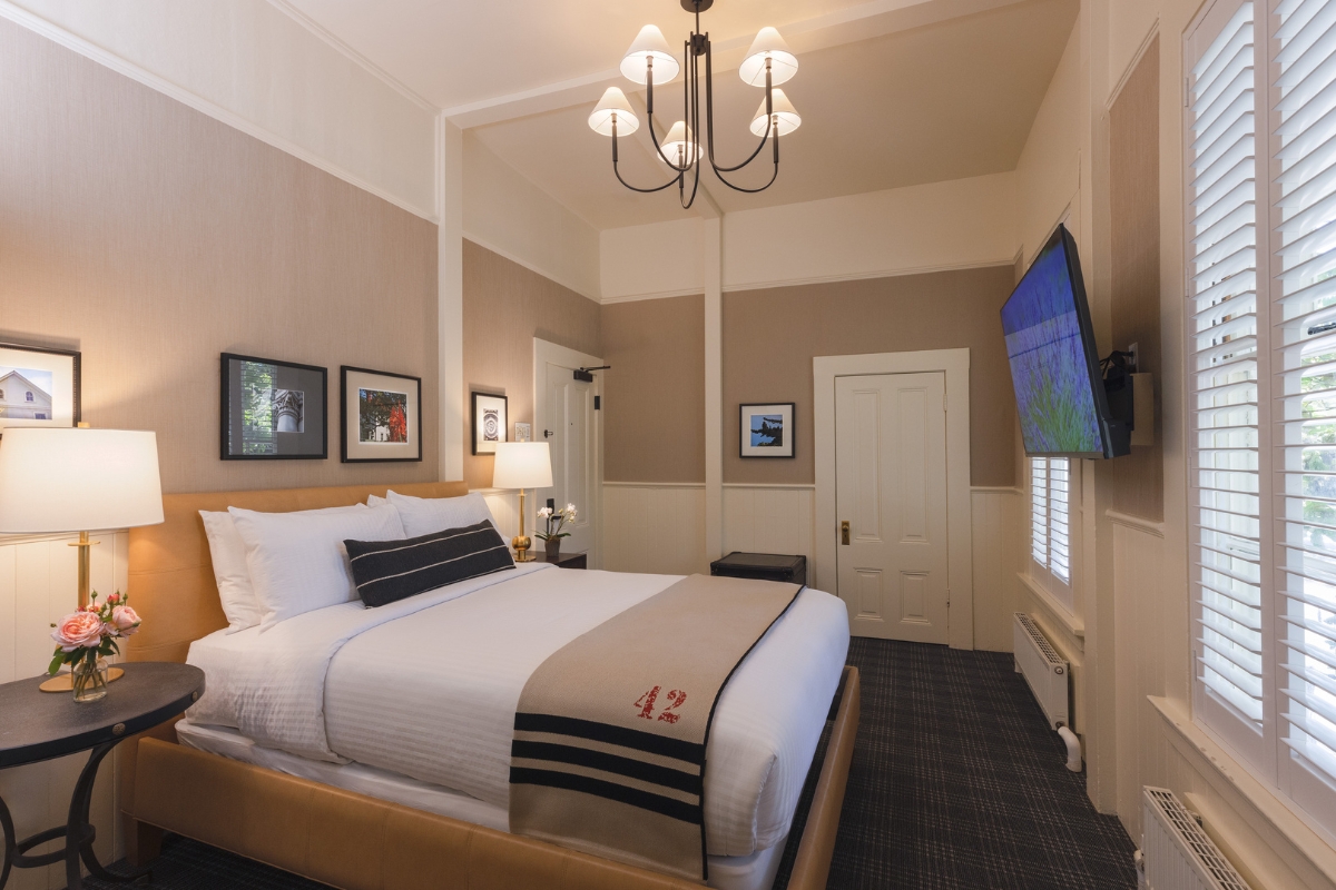a bedroom with a bed and a television