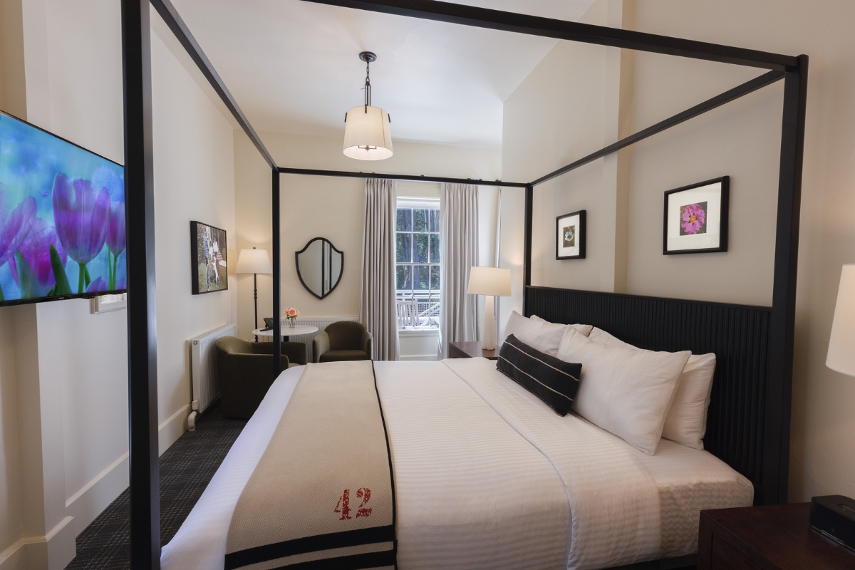 a bed with a four poster bed