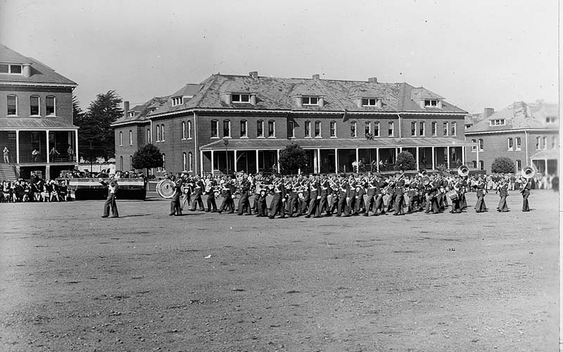 a group of people marching in front of a building