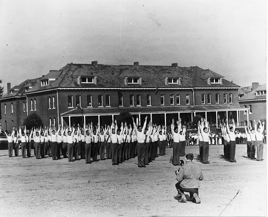 a group of people standing in a line with their arms raised