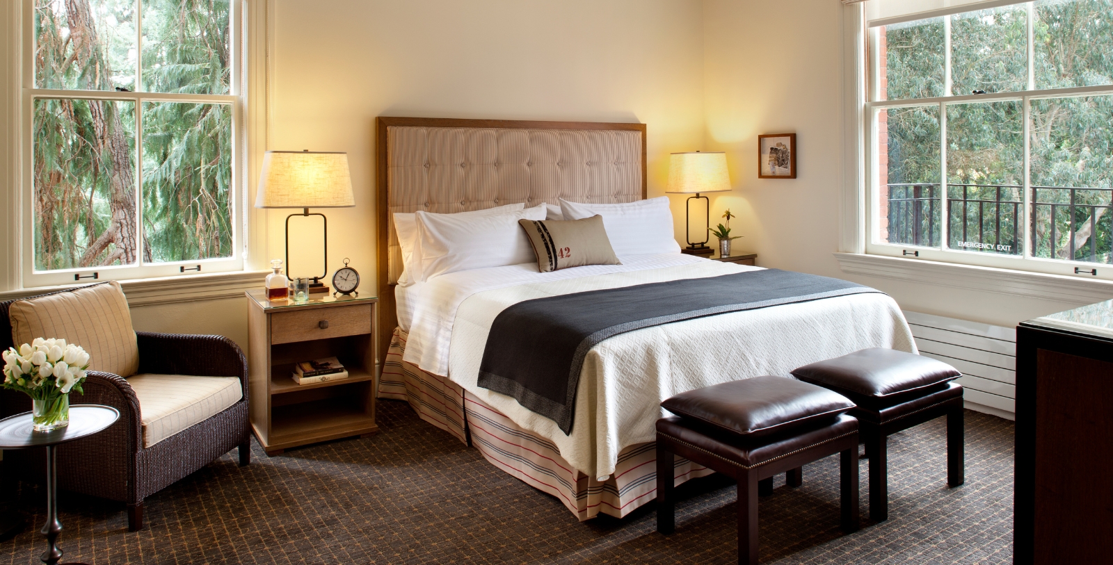 a bed with a headboard and two lamps