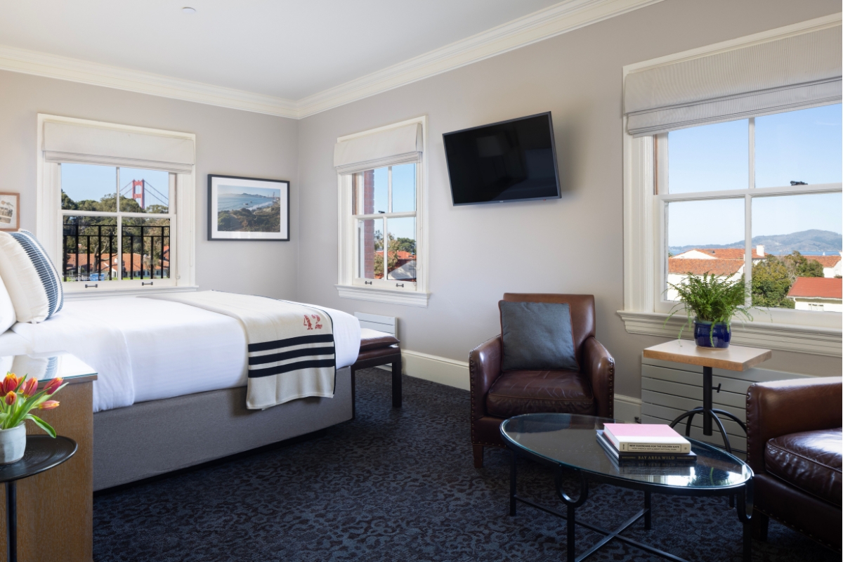 a room with a bed and a television