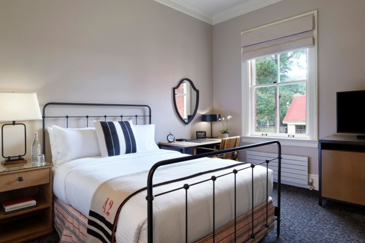 a bed with a mirror and a desk