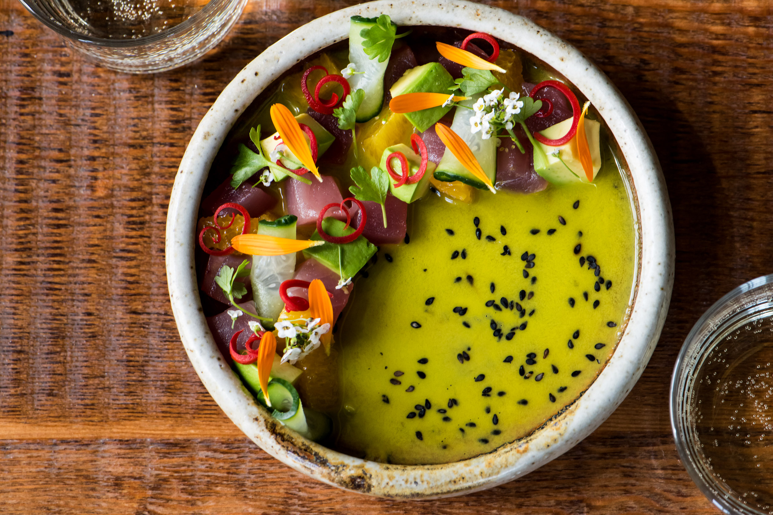 a bowl of food with vegetables and flowers