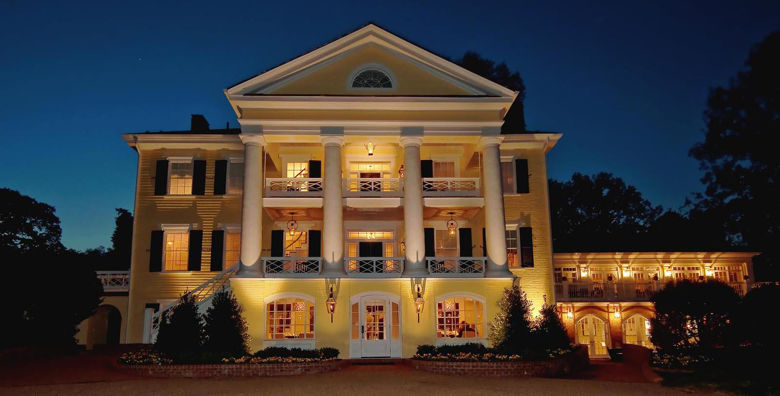 a large yellow house with white columns
