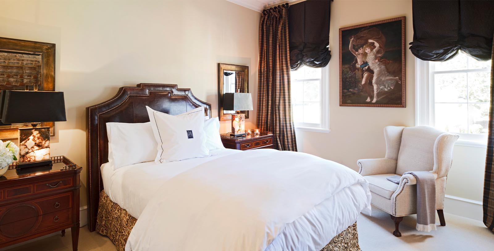a bedroom with a bed and a lamp