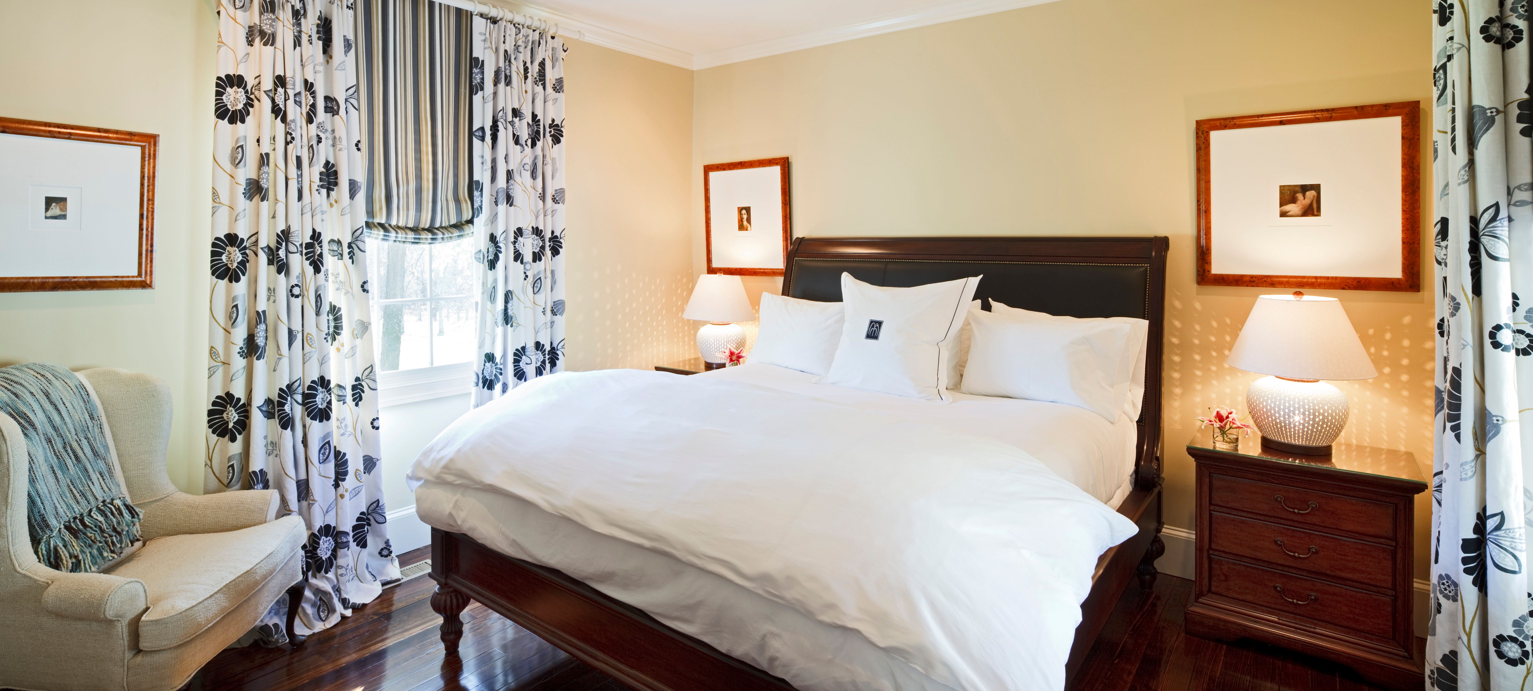 a bed with white sheets and pillows