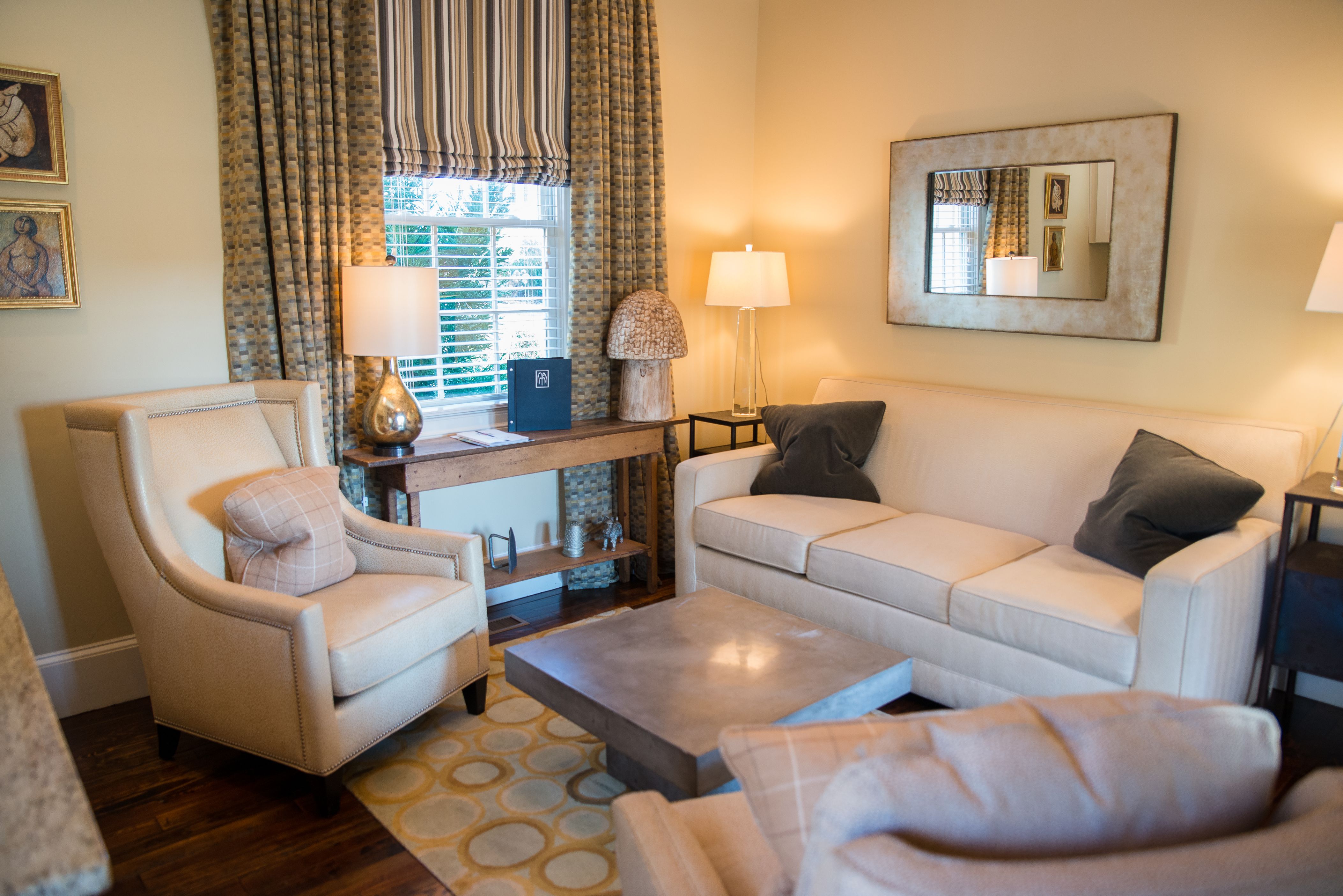 a living room with couches and chairs