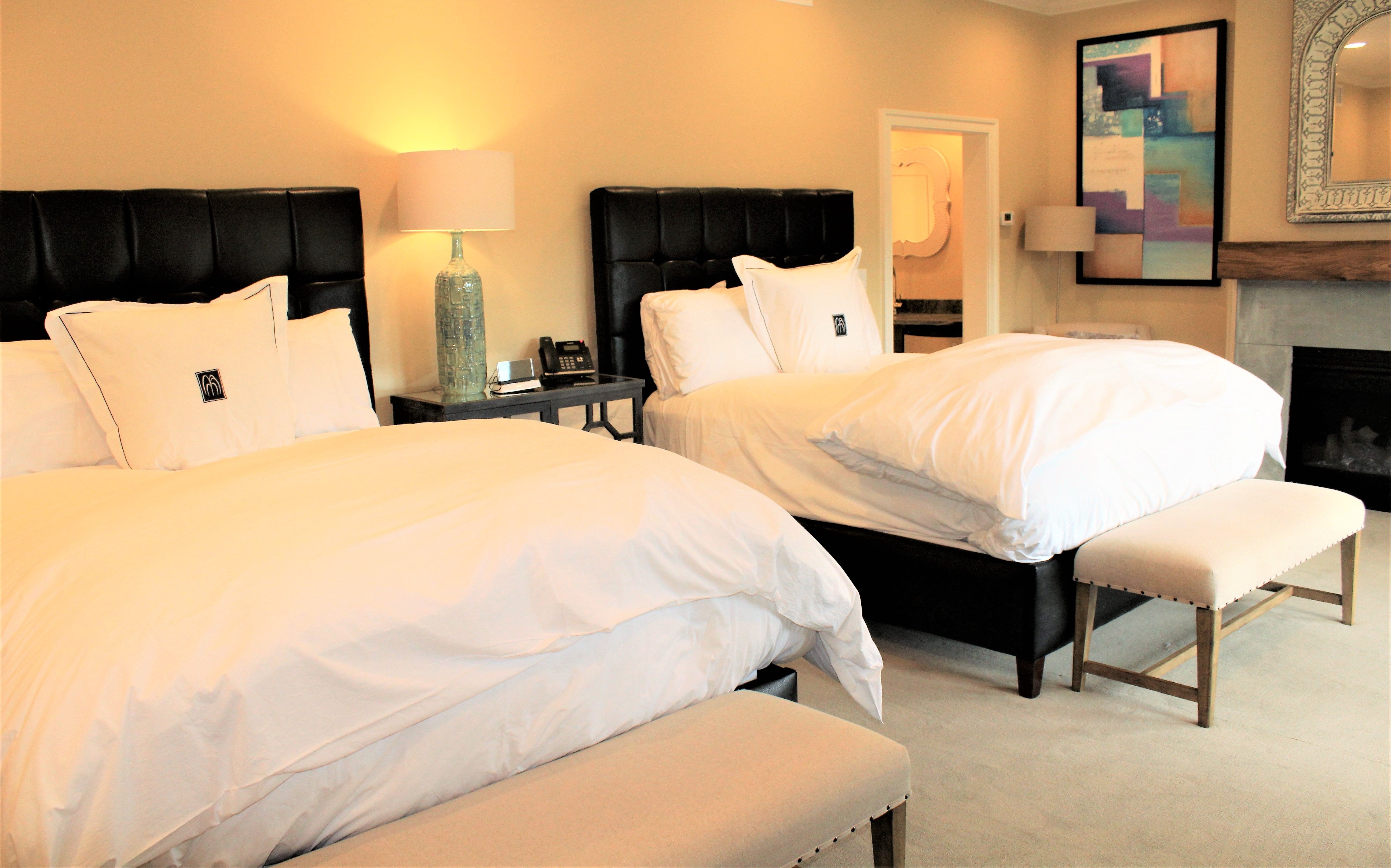 a room with two beds and a lamp
