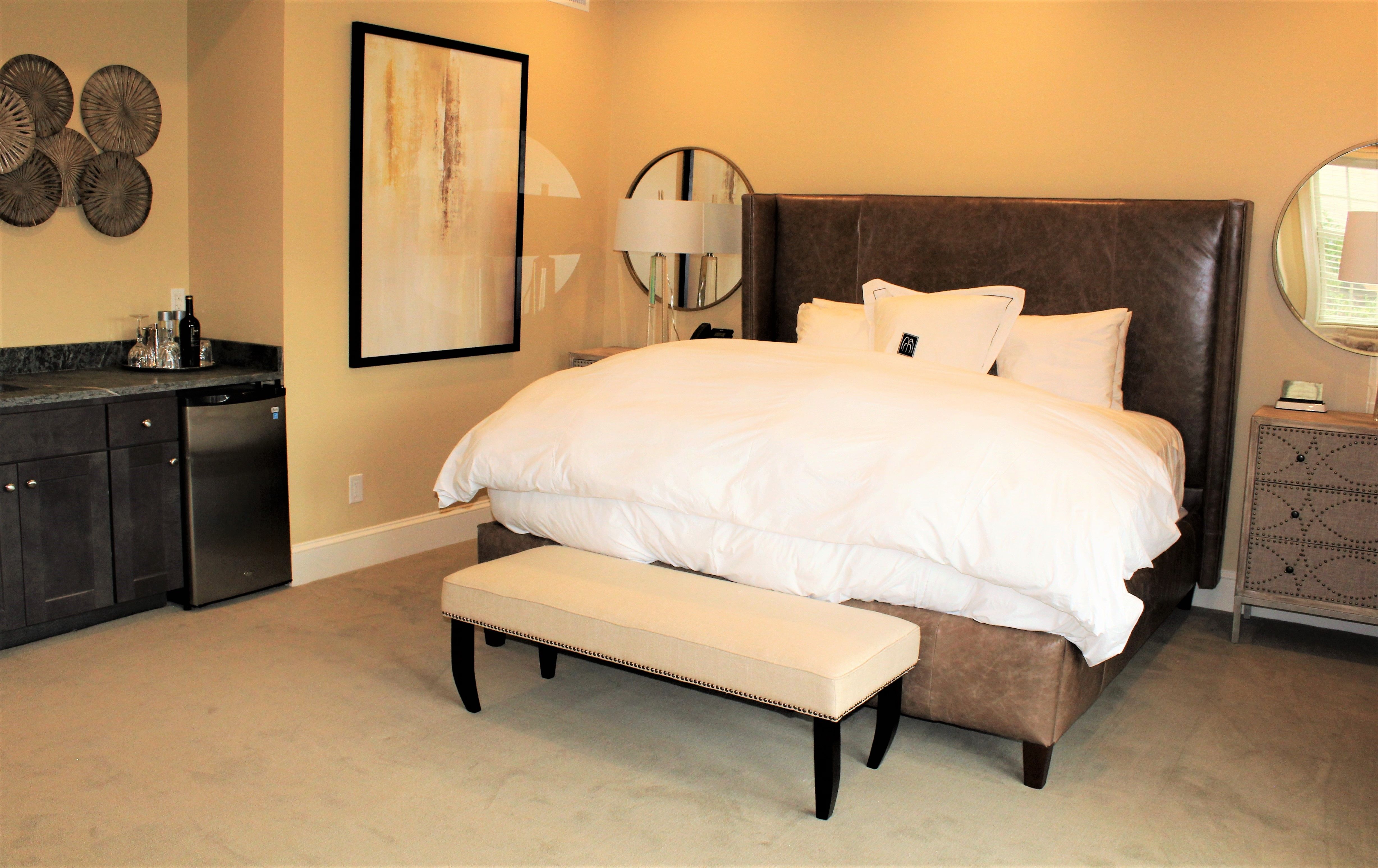 a bed with a bench in a room