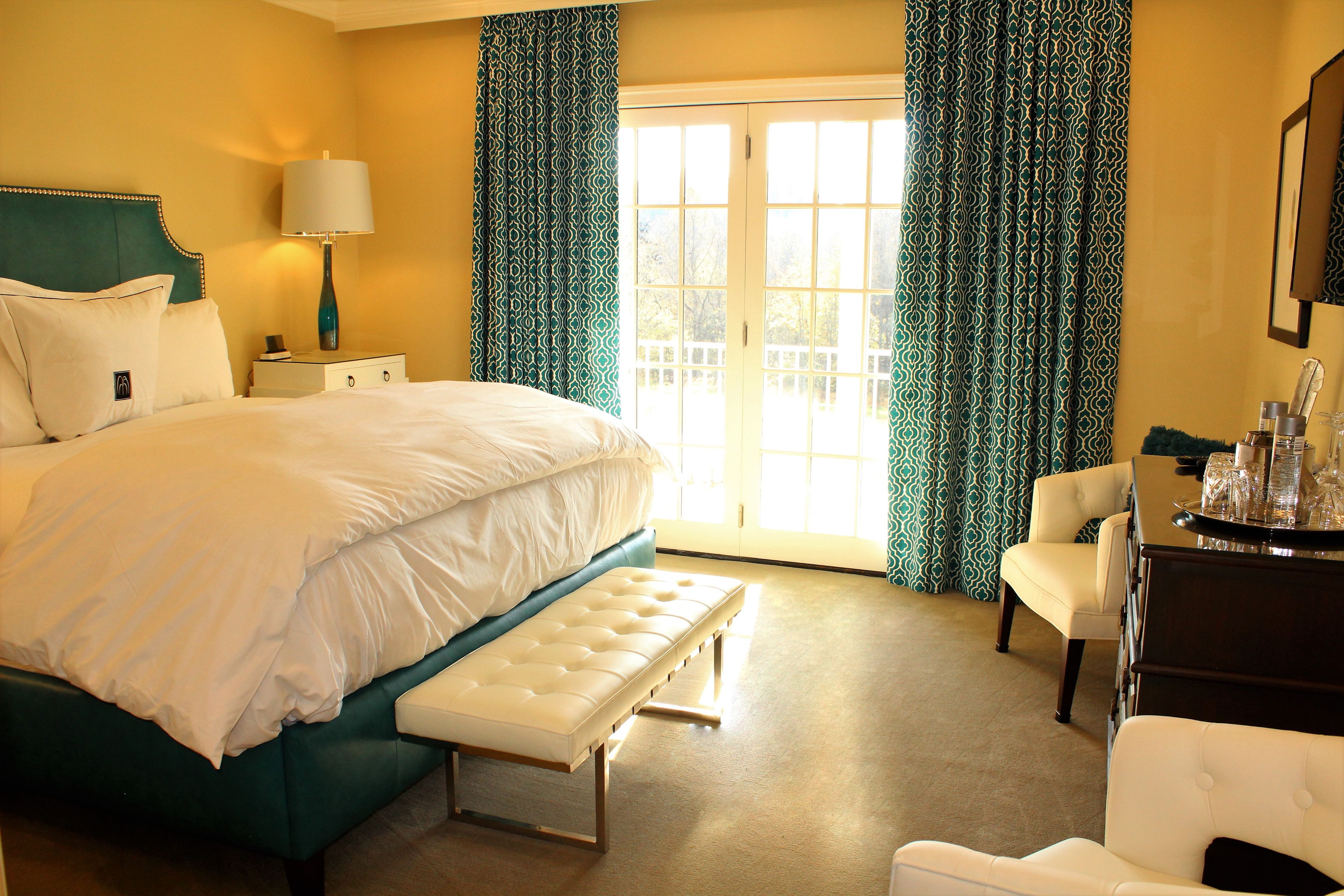 a bedroom with a bed and a bench