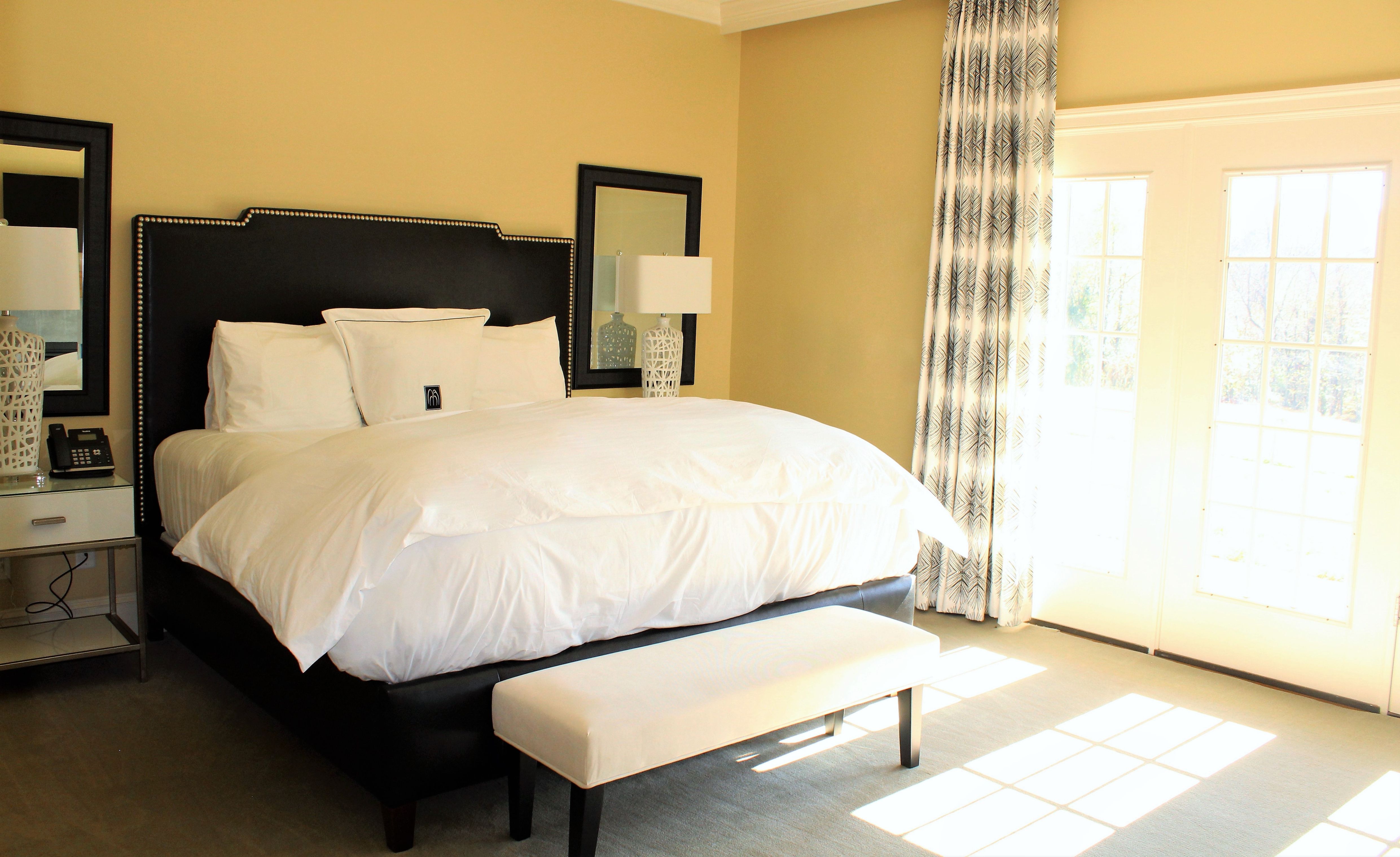 a bed with a bench in a room