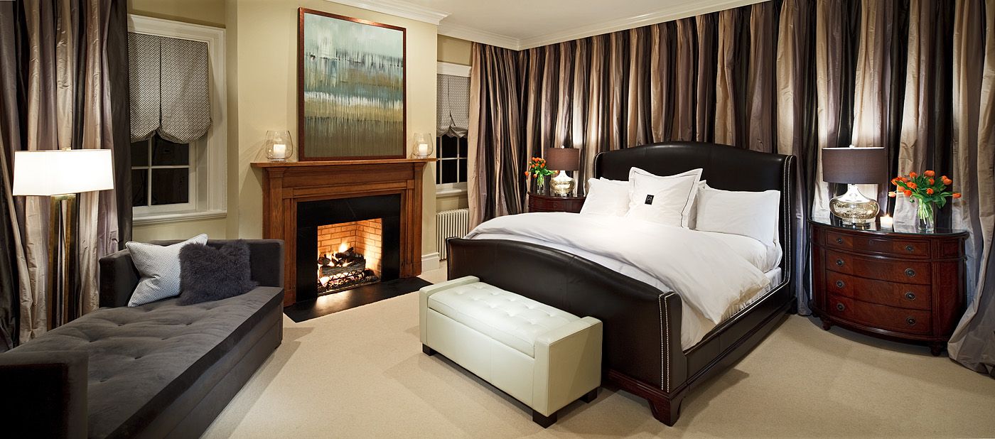 a bedroom with a fireplace and a bed