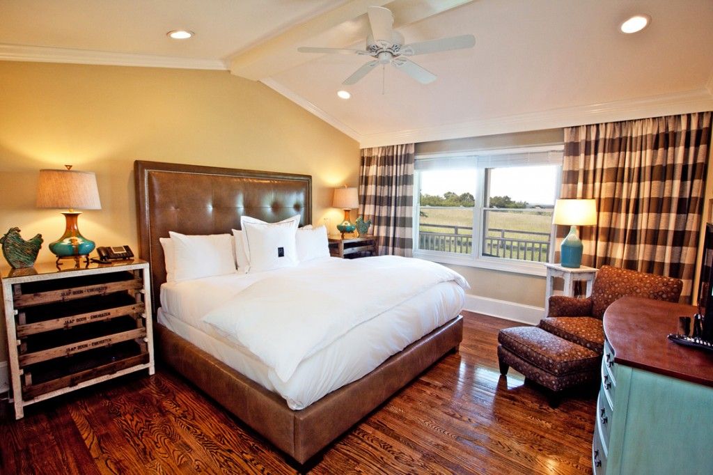 a bedroom with a large bed and a wood floor