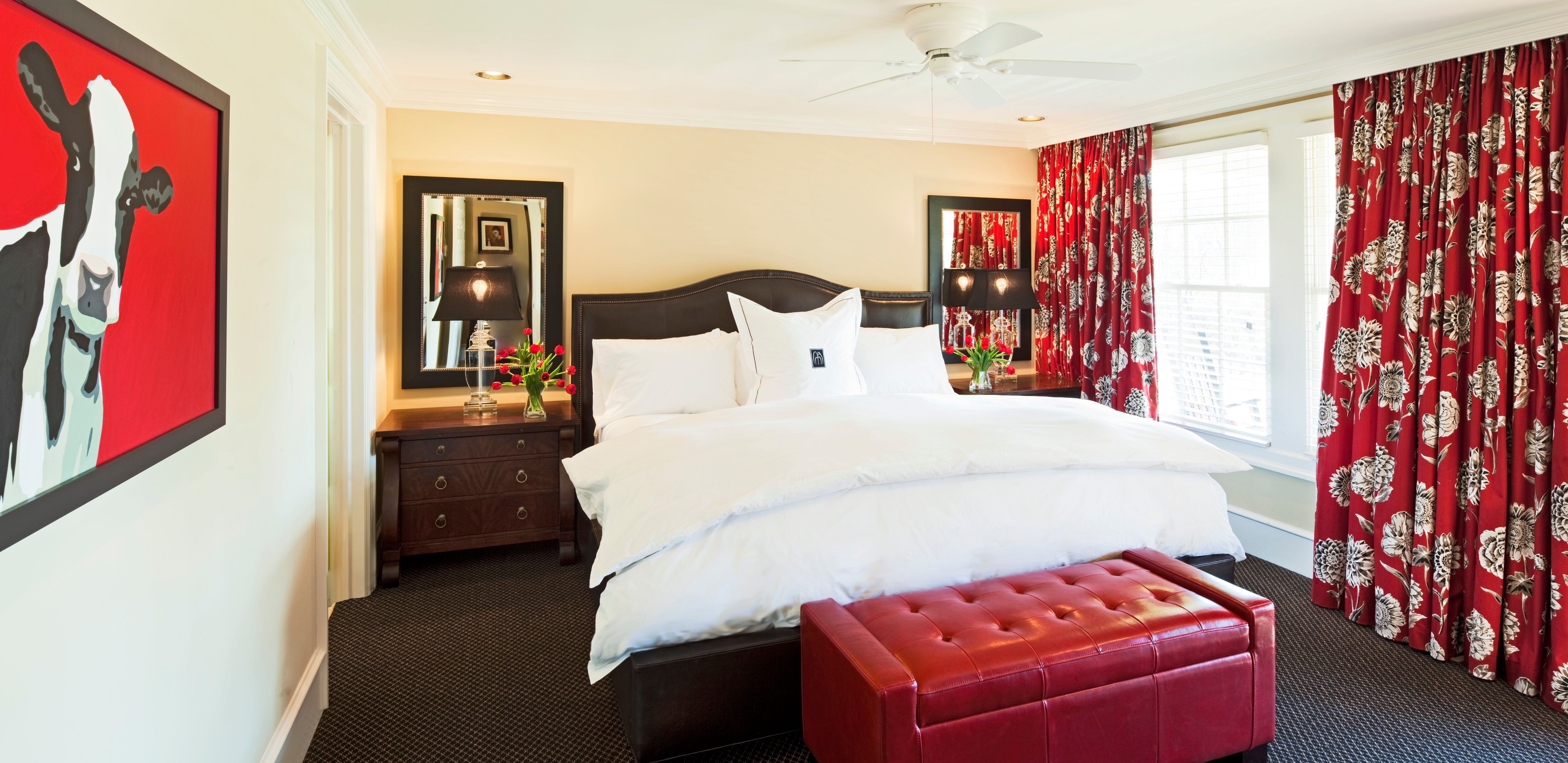 a bedroom with a bed and red curtains