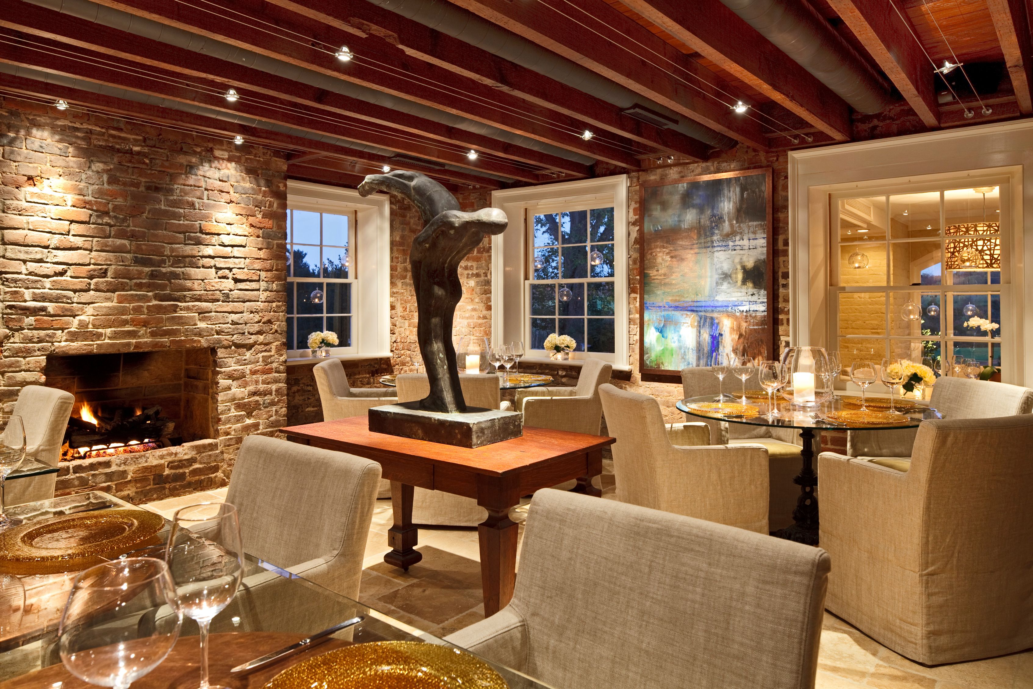 a room with a table and chairs and a sculpture