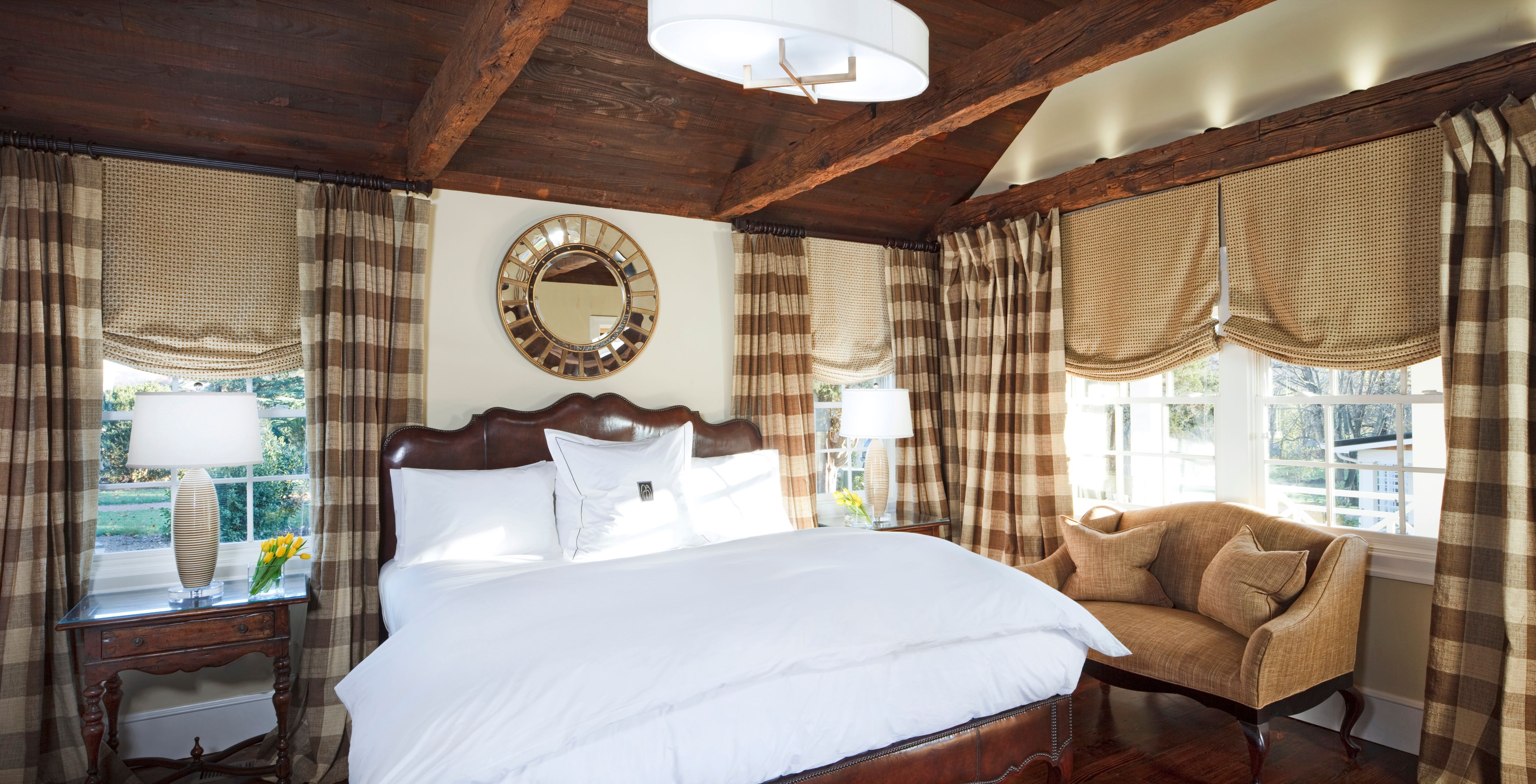 a bed with a mirror and a chair in a room
