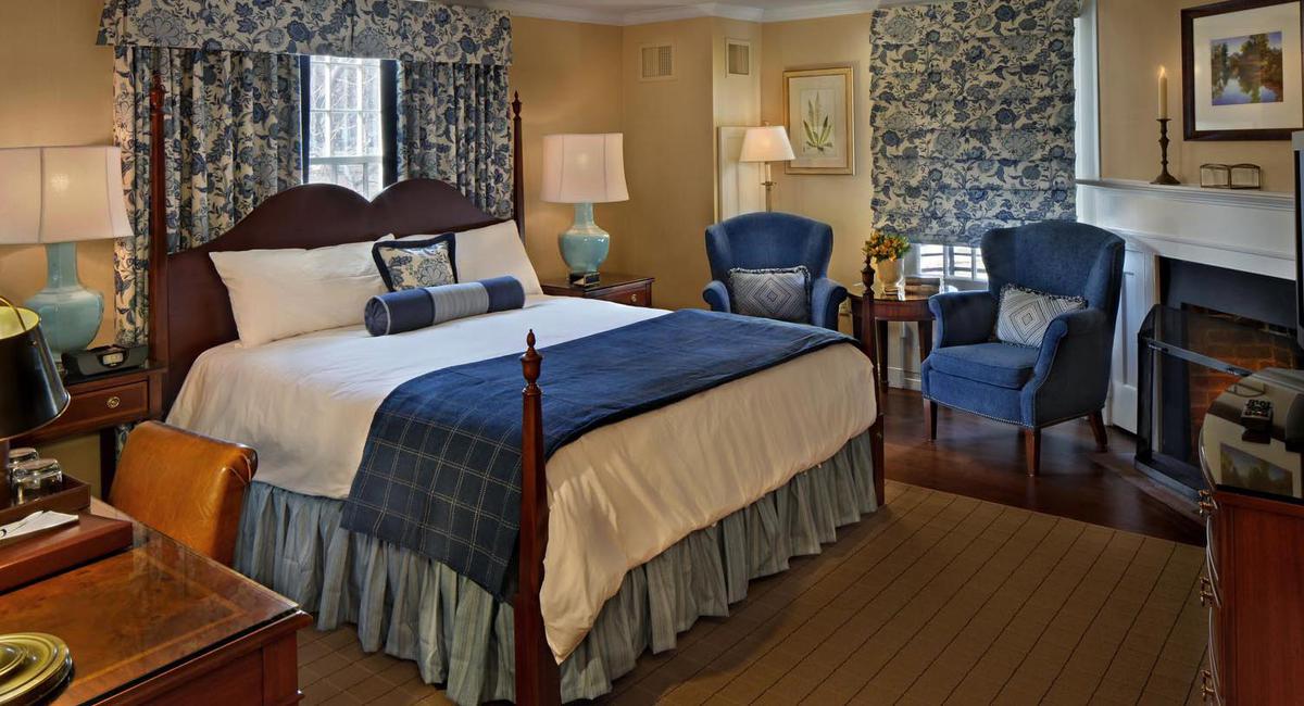 a bedroom with blue and white furniture